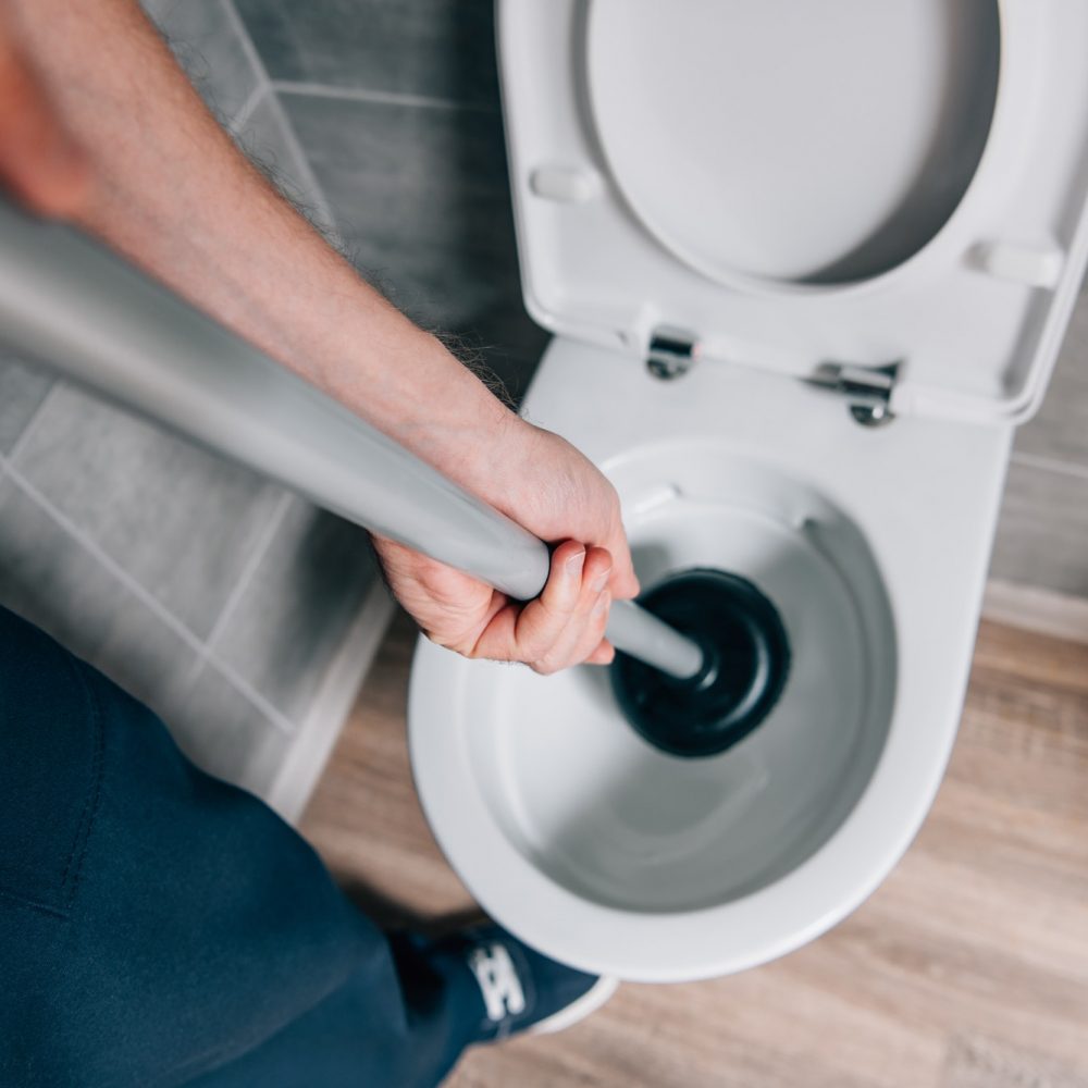 cropped-shot-of-male-plumber-using-plunger-and-cleaning-toilet-in-bathroom.jpg