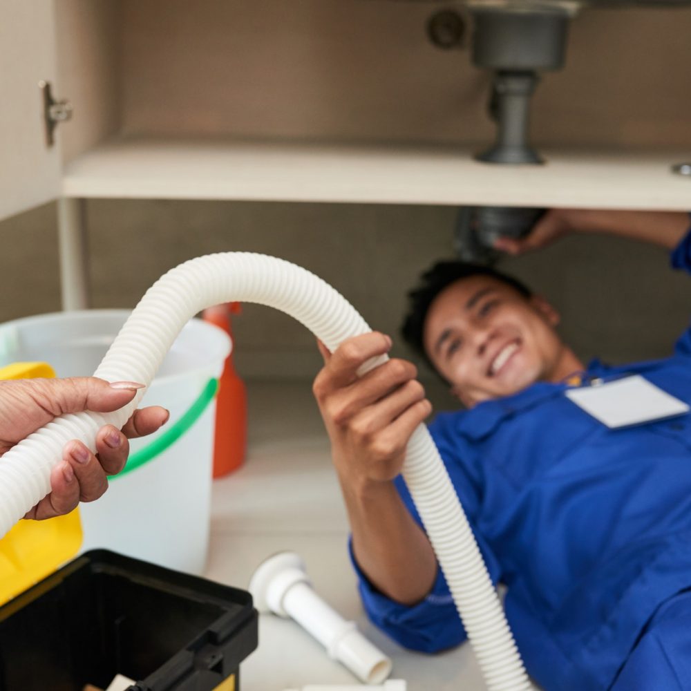 woman-giving-plastic-pipe-to-plumber.jpg